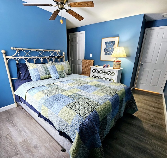 bedroom featuring dark hardwood / wood-style flooring and ceiling fan