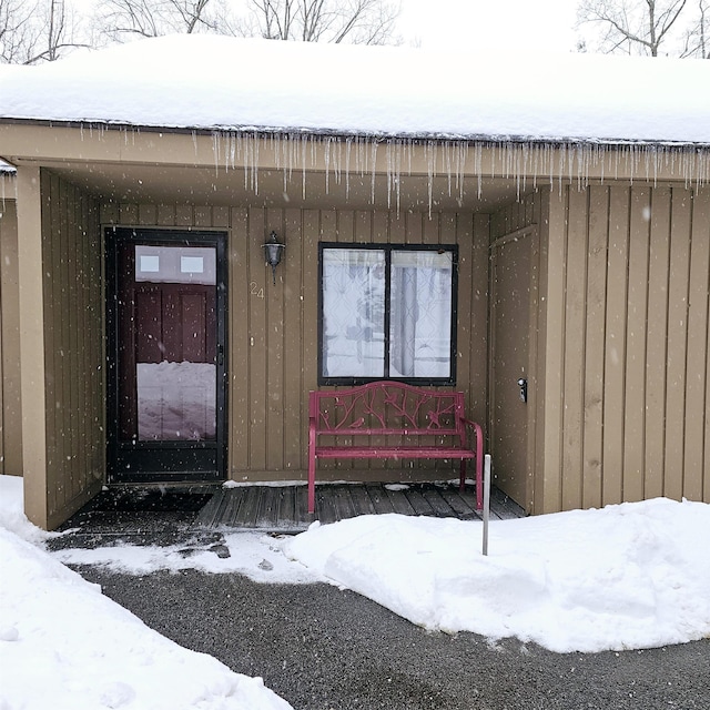 view of snow covered property entrance