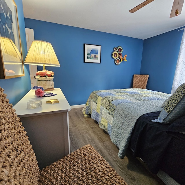 bedroom with dark wood-type flooring and ceiling fan