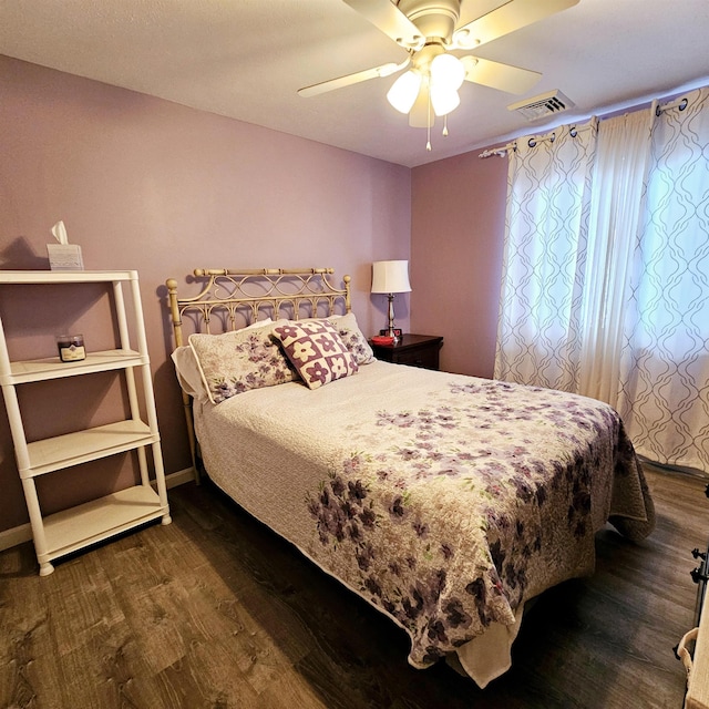 bedroom featuring dark wood-type flooring and ceiling fan