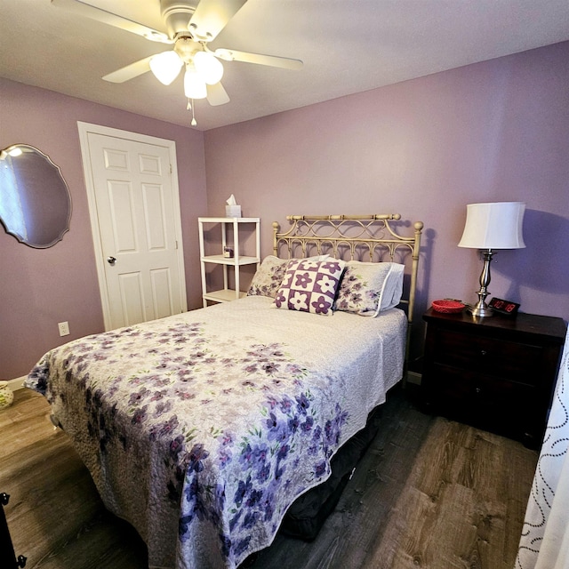 bedroom featuring dark hardwood / wood-style floors and ceiling fan