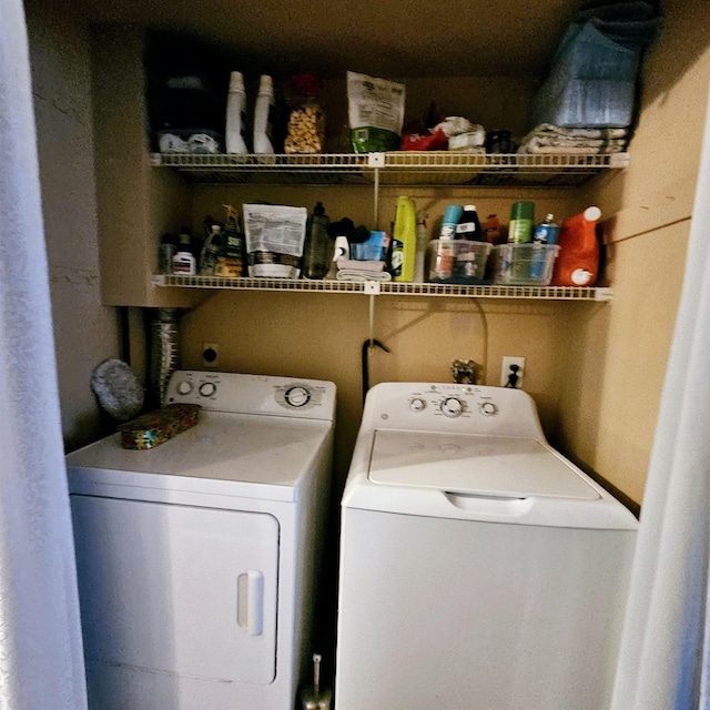 laundry room with washing machine and clothes dryer