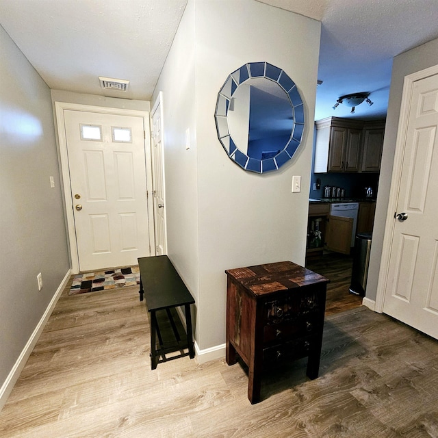 entryway with hardwood / wood-style flooring