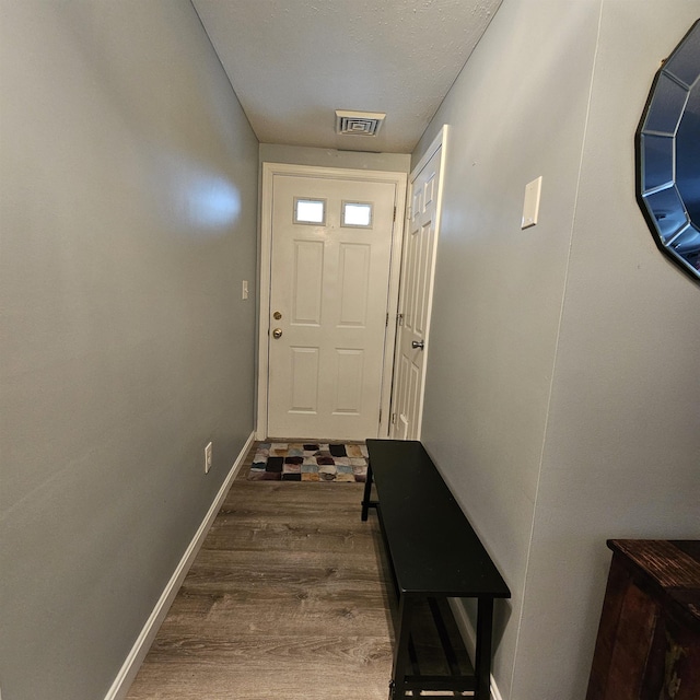 doorway with hardwood / wood-style flooring