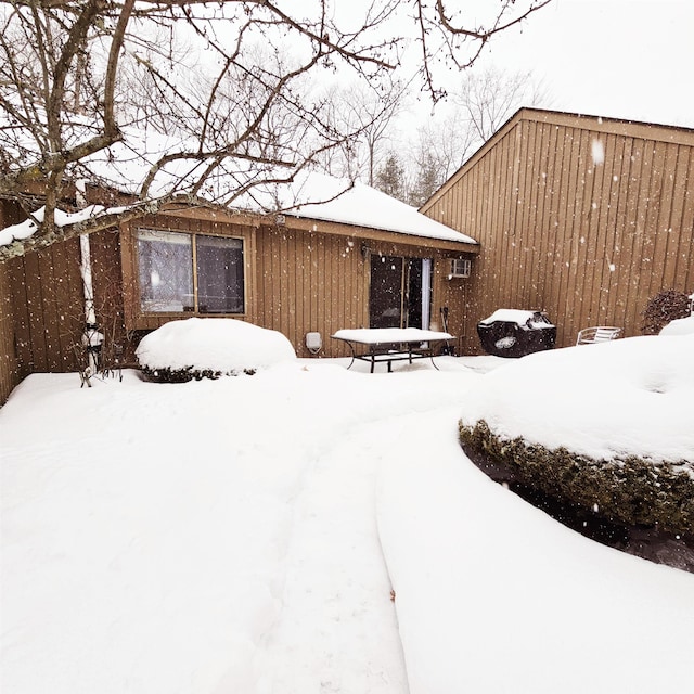 view of snow covered rear of property