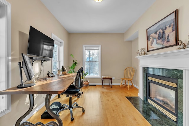 office with a premium fireplace and light wood-type flooring