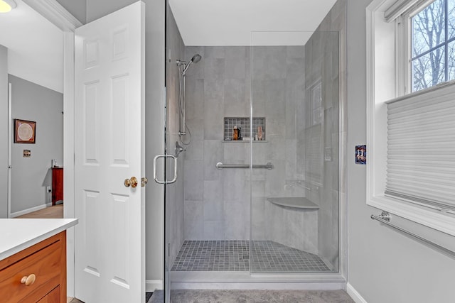 bathroom featuring vanity and a shower with shower door