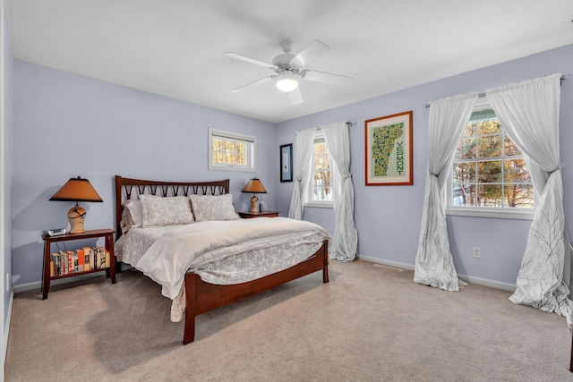 bedroom featuring light colored carpet and ceiling fan