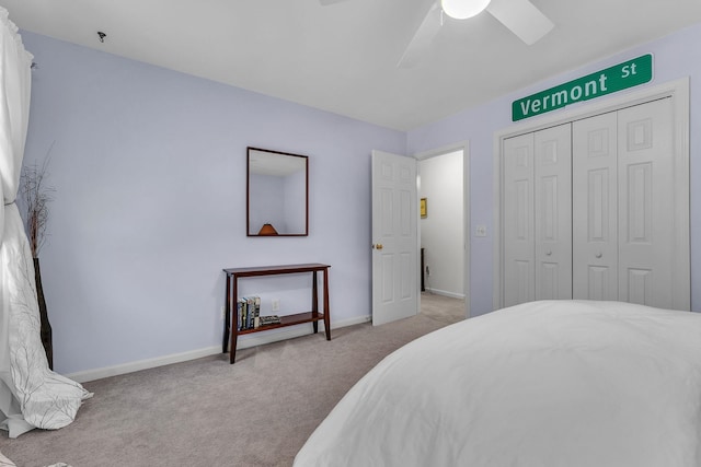 bedroom featuring ceiling fan, a closet, and light carpet