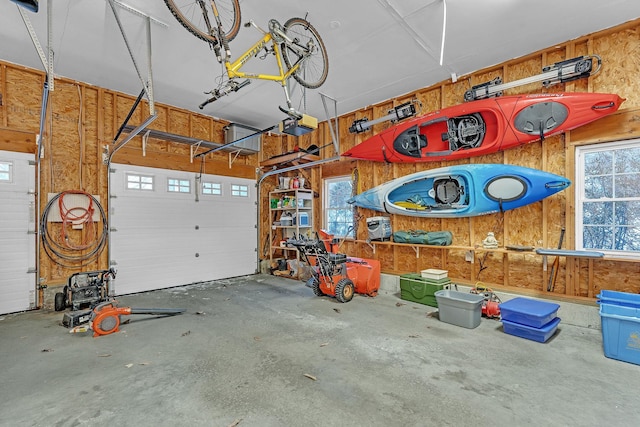 garage with a garage door opener and wooden walls