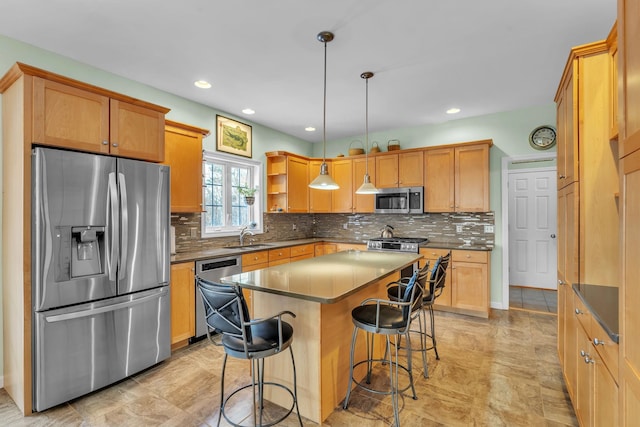 kitchen featuring a kitchen bar, decorative light fixtures, a center island, appliances with stainless steel finishes, and decorative backsplash