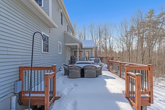 snow covered deck with a grill