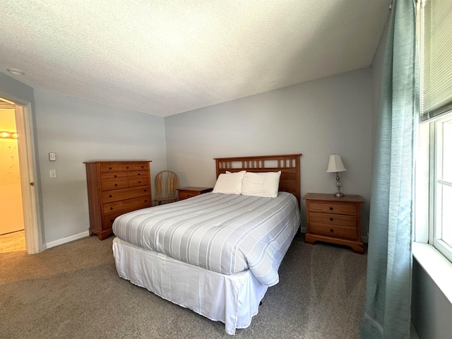 bedroom featuring carpet floors and a textured ceiling