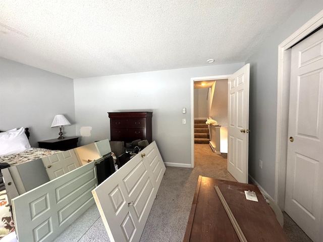 carpeted bedroom with a textured ceiling