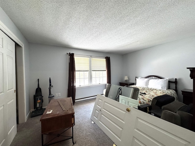 bedroom featuring carpet flooring, a textured ceiling, baseboard heating, and a closet