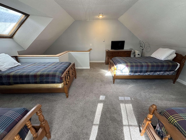 carpeted bedroom with vaulted ceiling with skylight and a textured ceiling