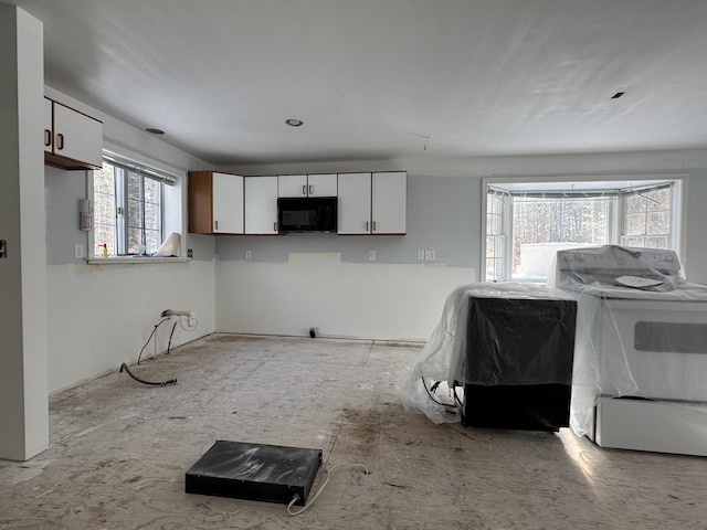 kitchen featuring white range with electric stovetop and white cabinets