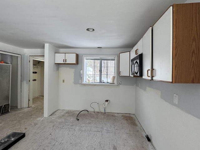 kitchen with fridge and white cabinets