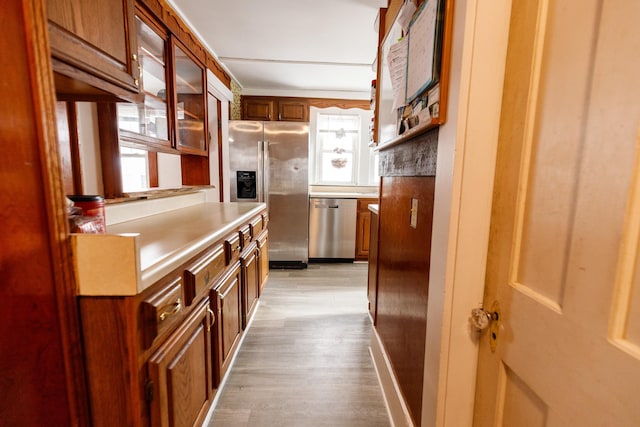 kitchen featuring light hardwood / wood-style flooring and appliances with stainless steel finishes