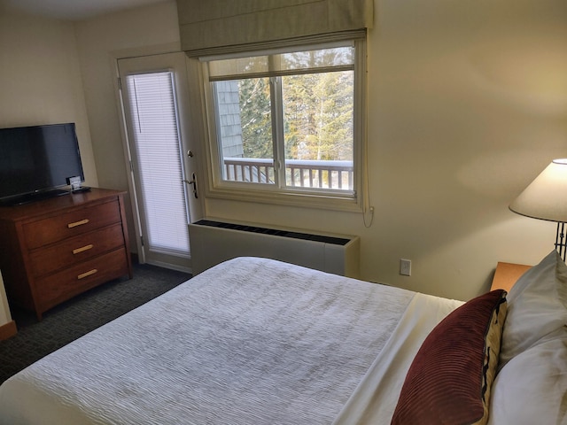 bedroom featuring radiator and dark carpet