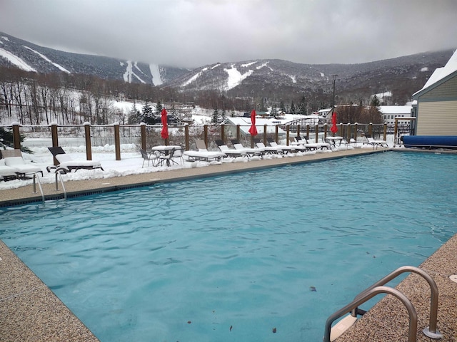 snow covered pool with a mountain view