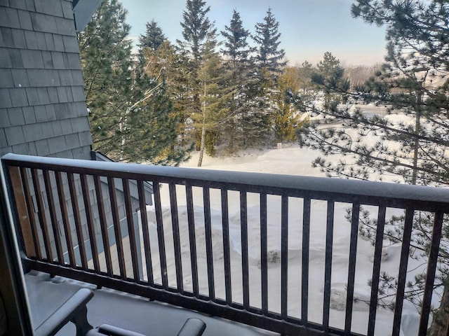 view of snow covered back of property