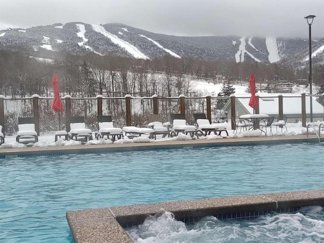 snow covered pool with a mountain view