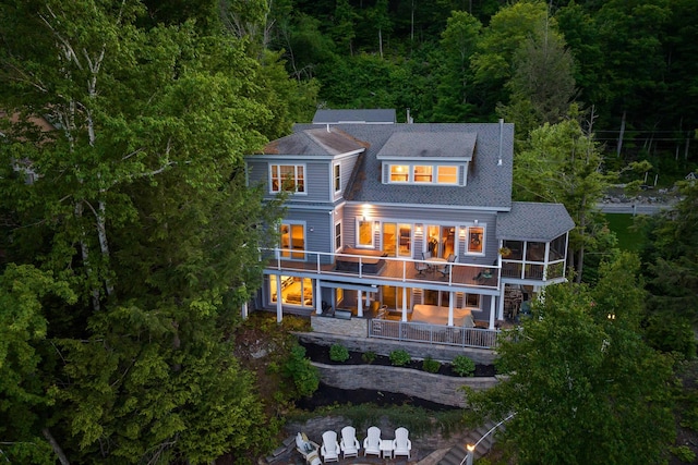 rear view of property featuring a patio and a balcony