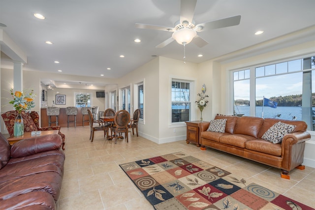 living room with ornate columns and ceiling fan