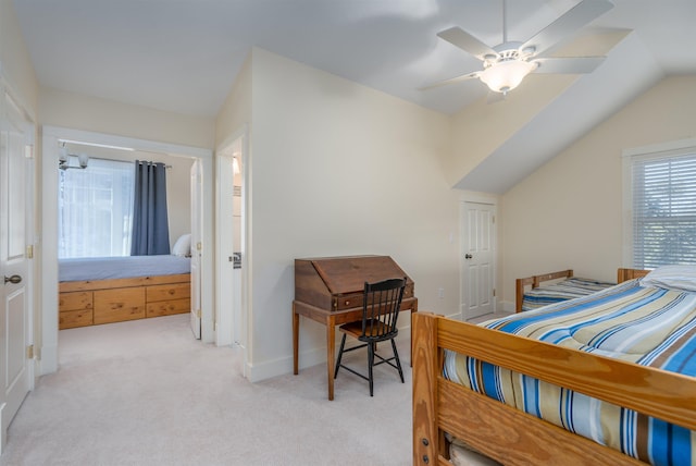 carpeted bedroom featuring ceiling fan and vaulted ceiling