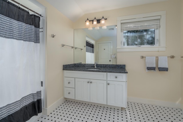 bathroom featuring vanity, curtained shower, and vaulted ceiling