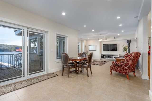 dining area with light tile patterned flooring and ceiling fan