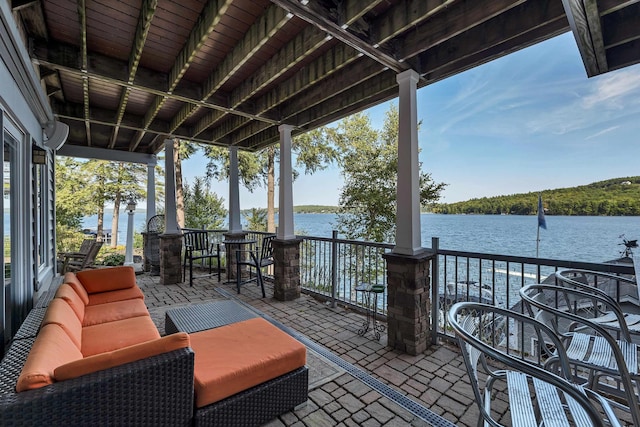 view of patio / terrace featuring a water view and an outdoor living space