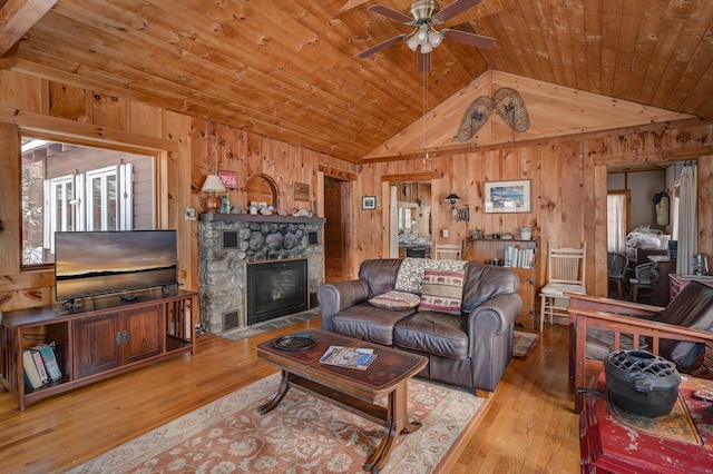 living room featuring lofted ceiling, wooden walls, light hardwood / wood-style flooring, and wooden ceiling