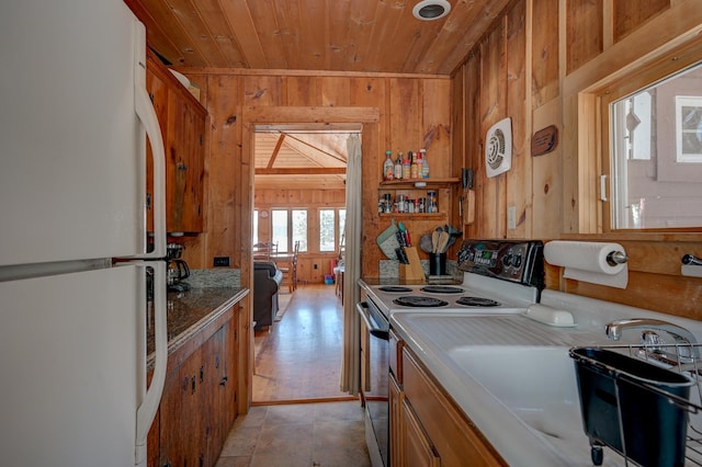 kitchen with electric stove, sink, wood ceiling, wooden walls, and white refrigerator