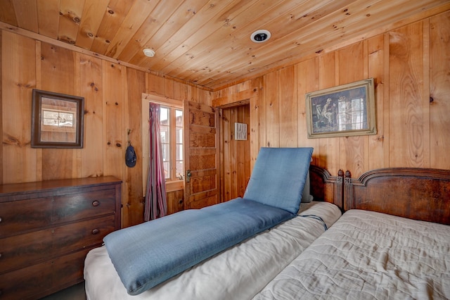 bedroom featuring wood ceiling and wood walls