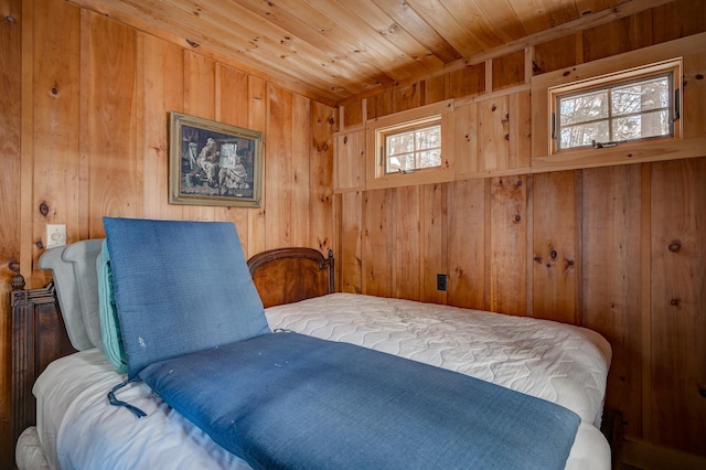 bedroom with wooden ceiling and wood walls