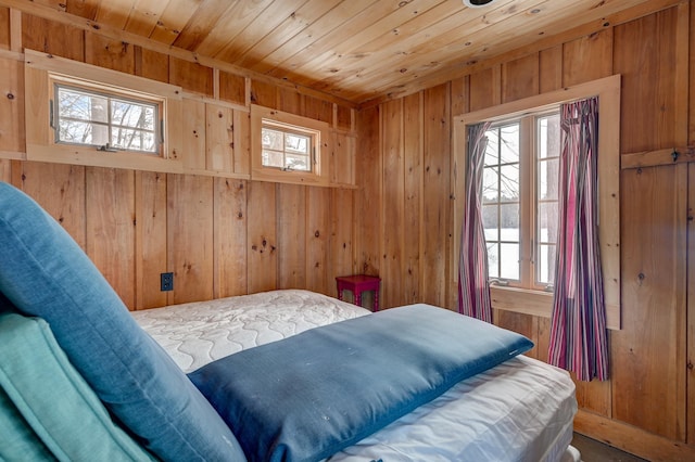 bedroom with wood ceiling and wooden walls