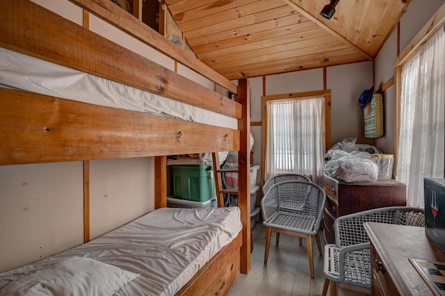 bedroom featuring lofted ceiling, wooden ceiling, and light hardwood / wood-style flooring