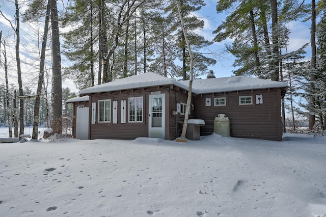 view of snow covered back of property