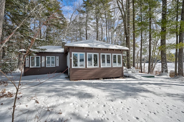 view of snow covered rear of property