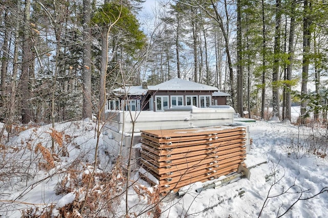 view of snow covered back of property