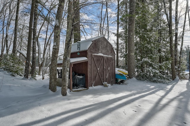 view of snowy exterior featuring an outdoor structure