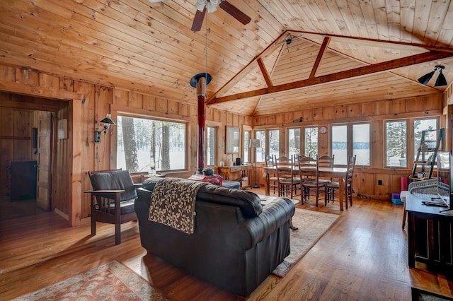 living room with plenty of natural light, hardwood / wood-style floors, and wood walls