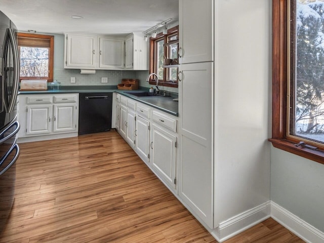 kitchen with sink, white cabinetry, stainless steel fridge with ice dispenser, black dishwasher, and light hardwood / wood-style floors