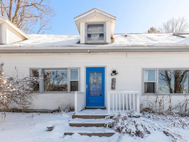 view of snow covered property entrance