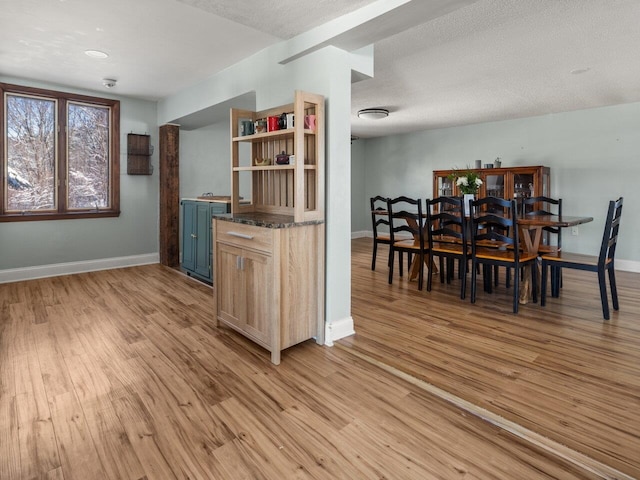 kitchen featuring a textured ceiling, light brown cabinets, and light wood-type flooring