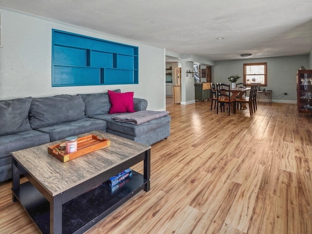 living room featuring wood-type flooring and a textured ceiling