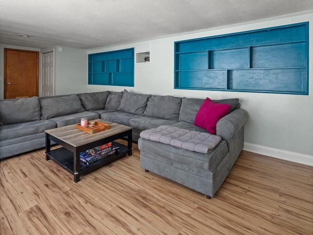 living room featuring light hardwood / wood-style floors and a textured ceiling