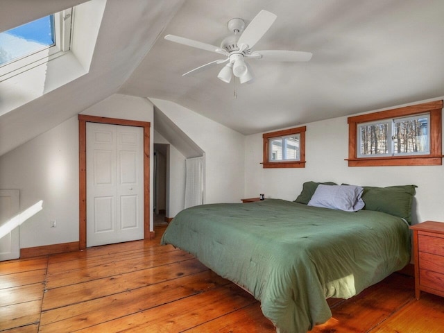 bedroom featuring lofted ceiling, hardwood / wood-style floors, and ceiling fan